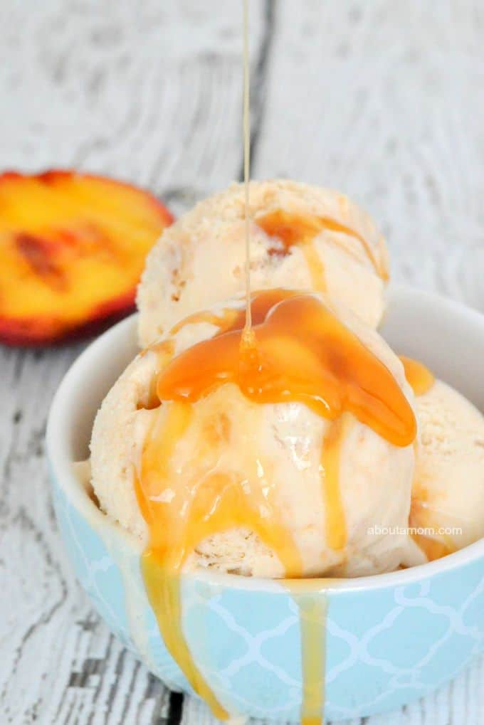 Scoops of grilled peach ice cream in a blue bowl, drizzled with caramel sauce.