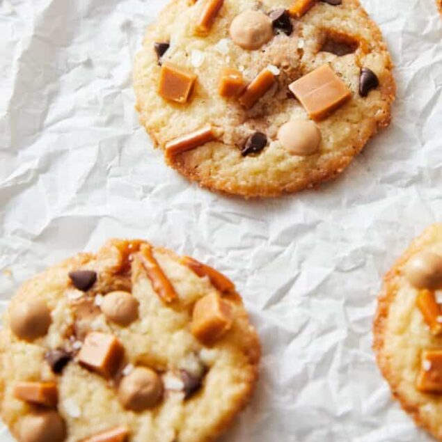 Kitchen Sink Cookies with chocolate chips, caramel bits, pretzel sticks, and flaky sea salt.