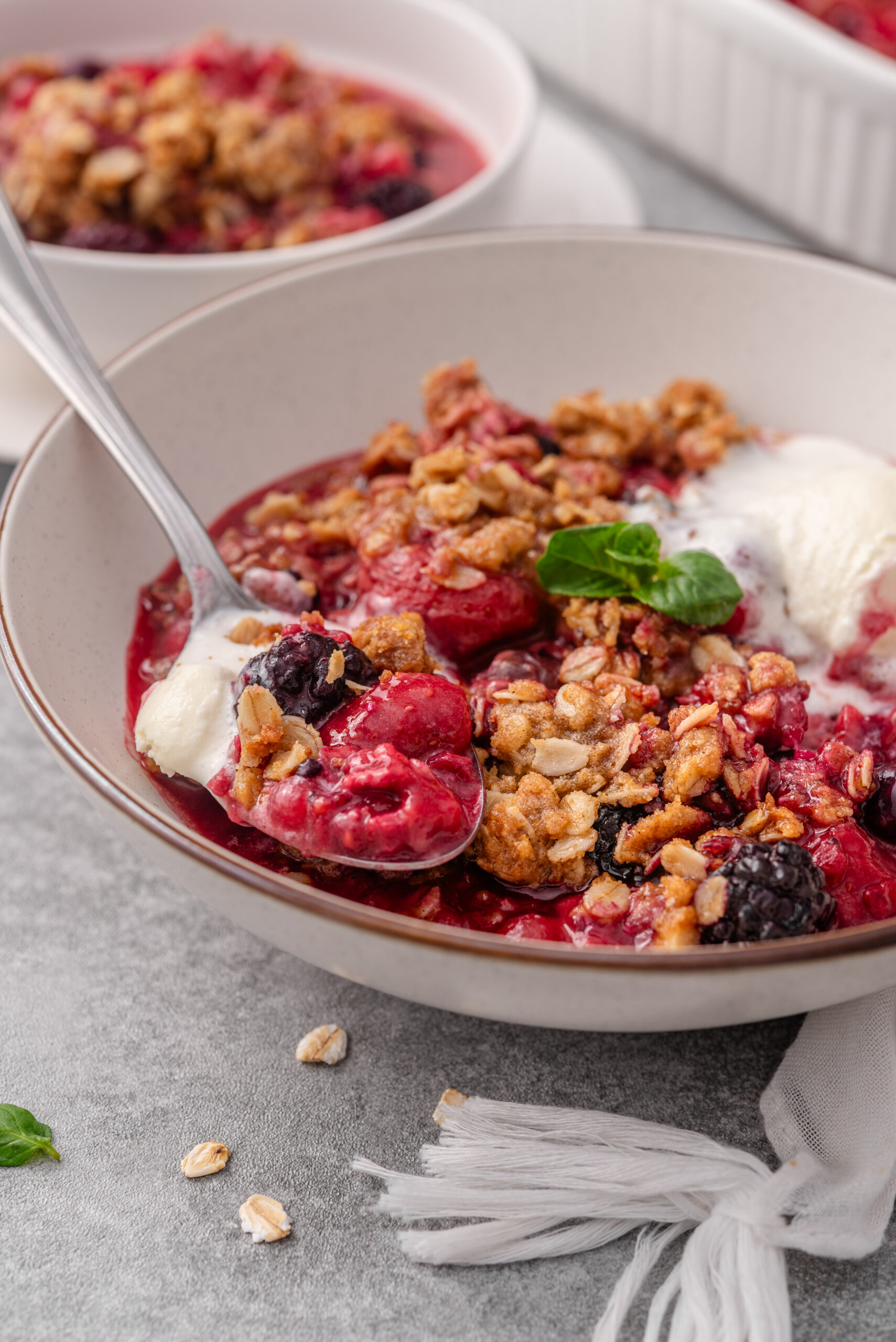Berry crisp recipe in a bowl shot from diagonal