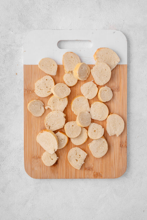 Sliced plain bagels on a cutting board for Bagel Chips.
