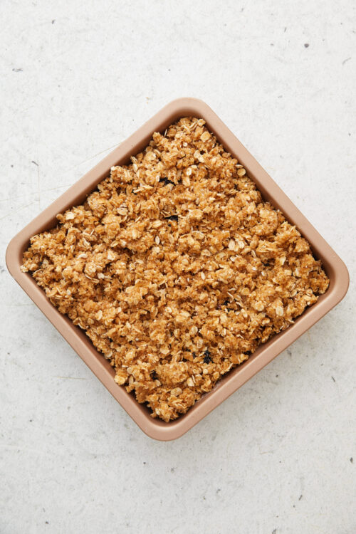 Blackberry crisp with a golden oat topping in a baking dish.