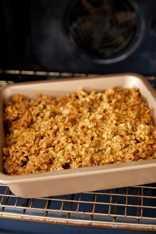 Blackberry Crisp baking in a rectangular dish with oat topping.