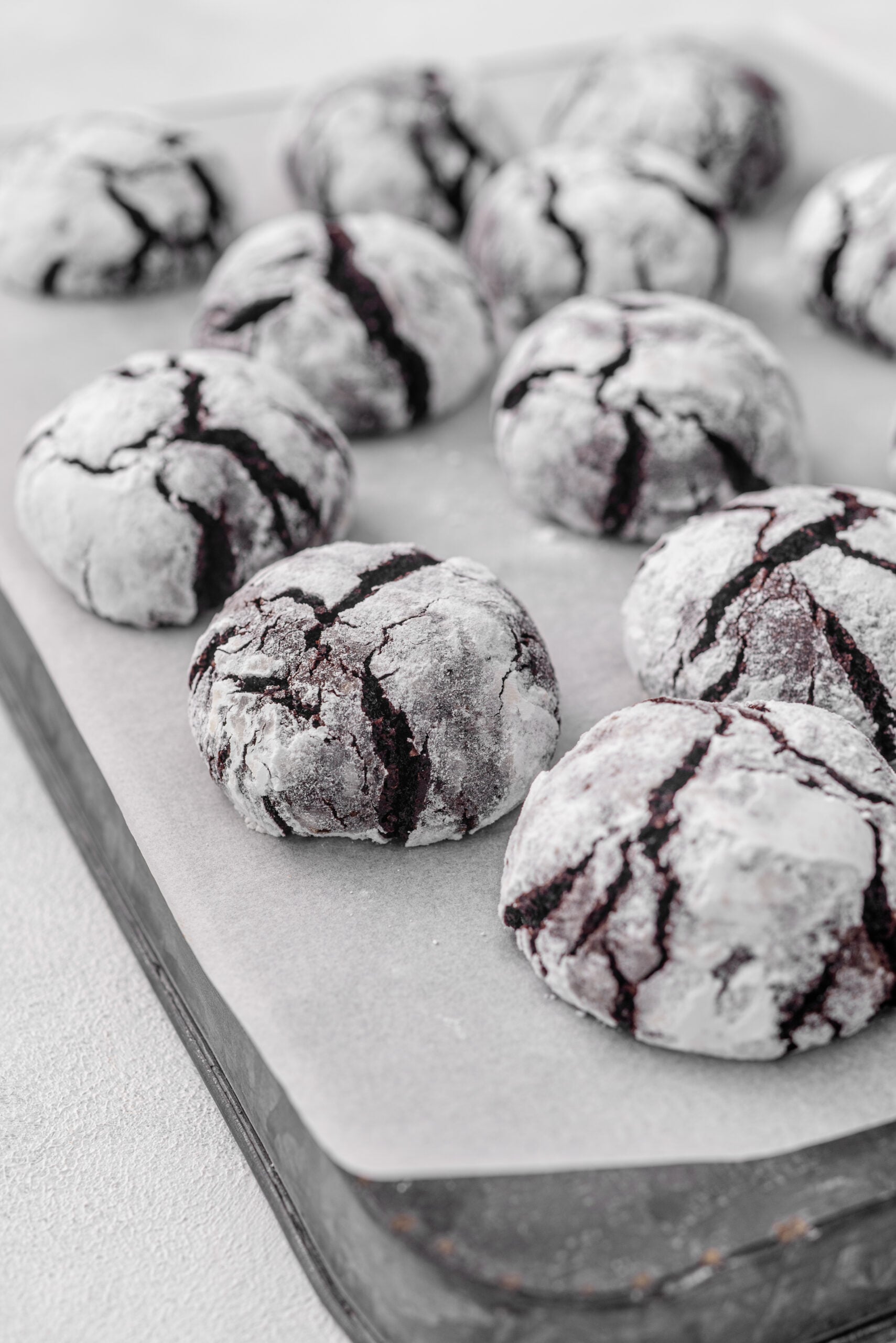 Chocolate Crinkle Cookies on a sheet pan diagonal shot