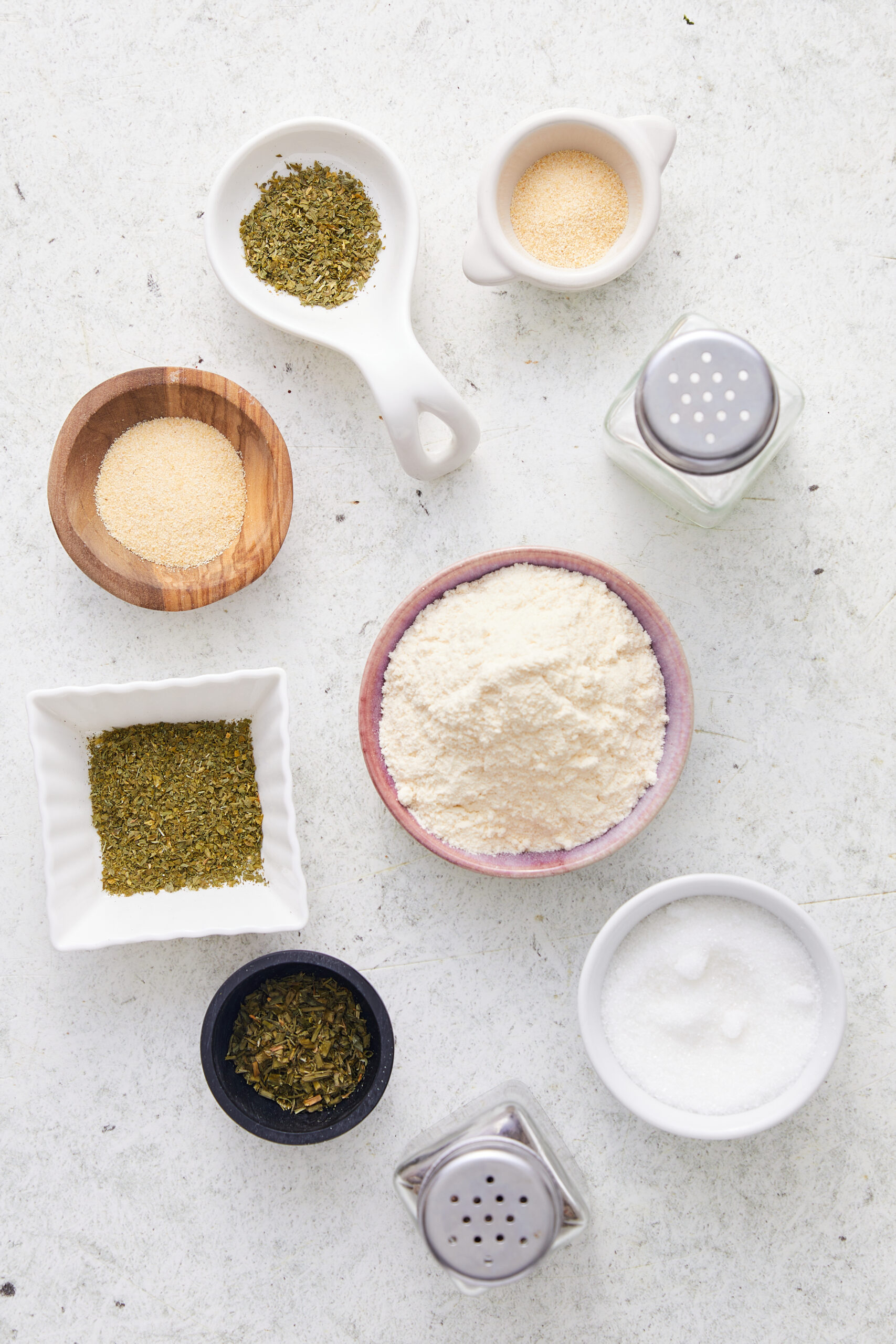 Ingredients for homemade ranch seasoning: buttermilk powder, garlic powder, onion powder, dried parsley, dried dill weed, dried chives, sugar, and salt.