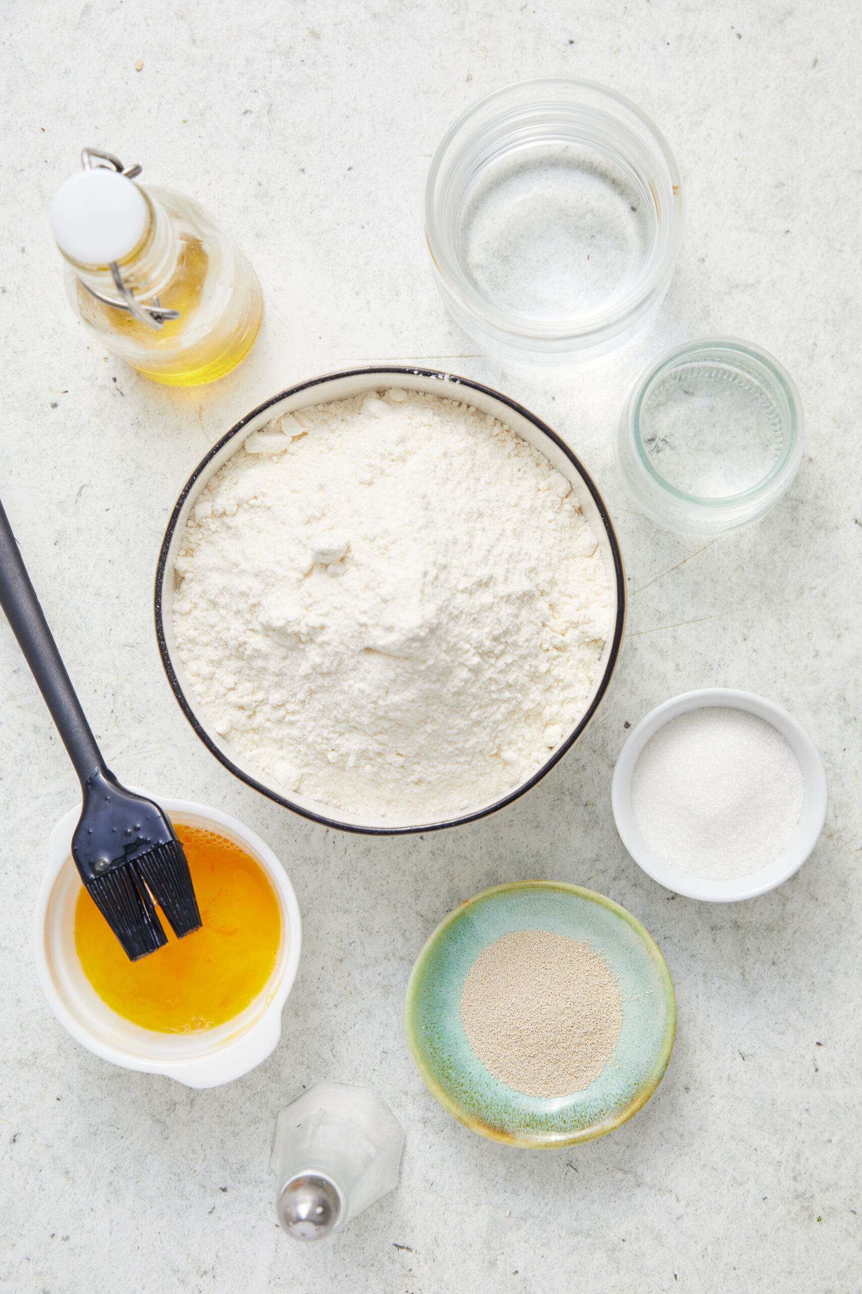 Ingredients for Italian Bread Recipe: bread flour, active dry yeast, granulated sugar, salt, olive oil, water, and egg wash.