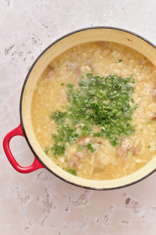 Senate Bean Soup in a red pot, garnished with fresh parsley.