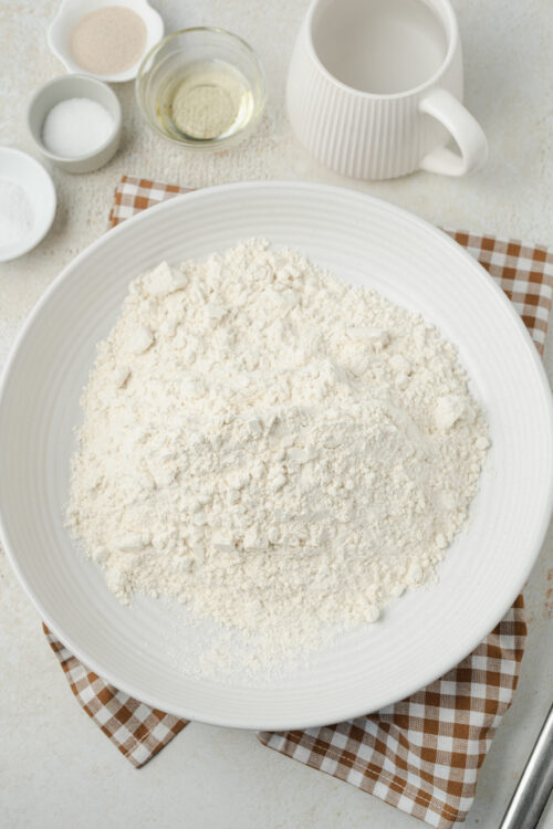 Artisan bread ingredients: flour, yeast, sugar, salt, oil, water.