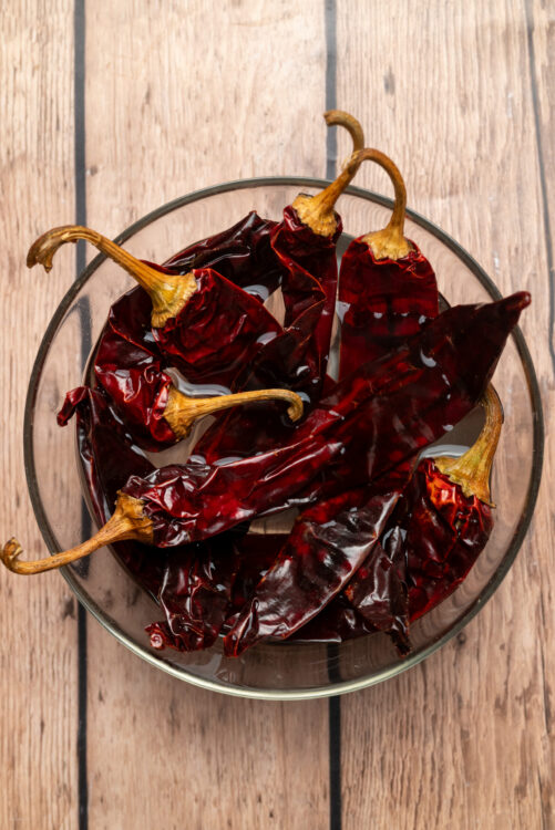 Soaking dried chiles in hot water for homemade harissa.