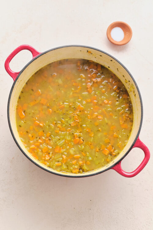 Vegan split pea soup simmering with carrots and celery.