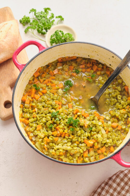 Vegan split pea soup with carrots, parsley, and crusty bread.