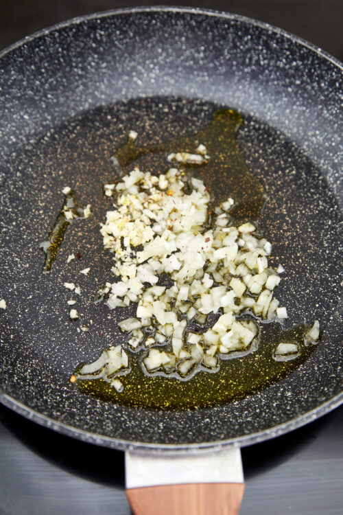 Cooking onion and garlic for vodka sauce.